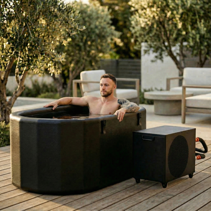 Man relaxing in an outdoor hot tub with a music system next to it